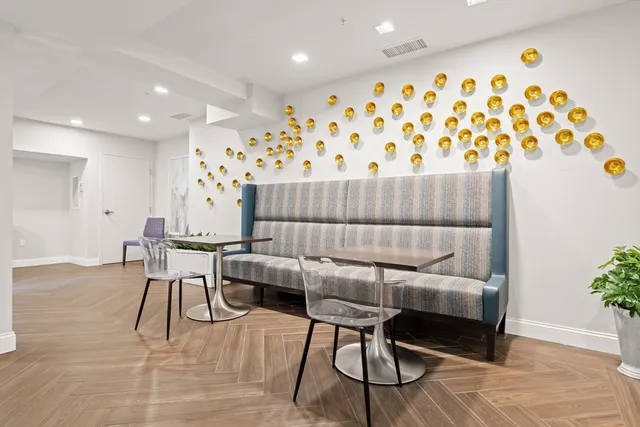 a dining room with furniture and wooden floor