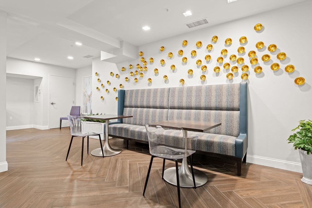 771 Harrison Avenue, Unit 206 Boston, MA 02118 - Photo 17 of 22 a dining room with furniture and wooden floor