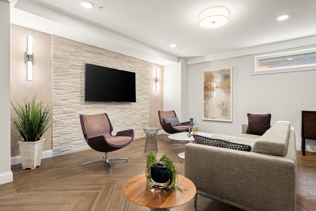 771 Harrison Avenue, Unit 206 Boston, MA 02118 - Photo 18 of 22 a living room with furniture and a flat screen tv