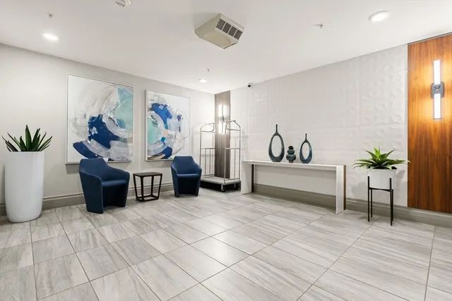 a living room with furniture and a potted plant