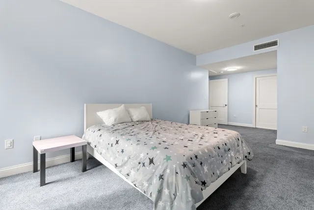 a bedroom with a bed and a lamp