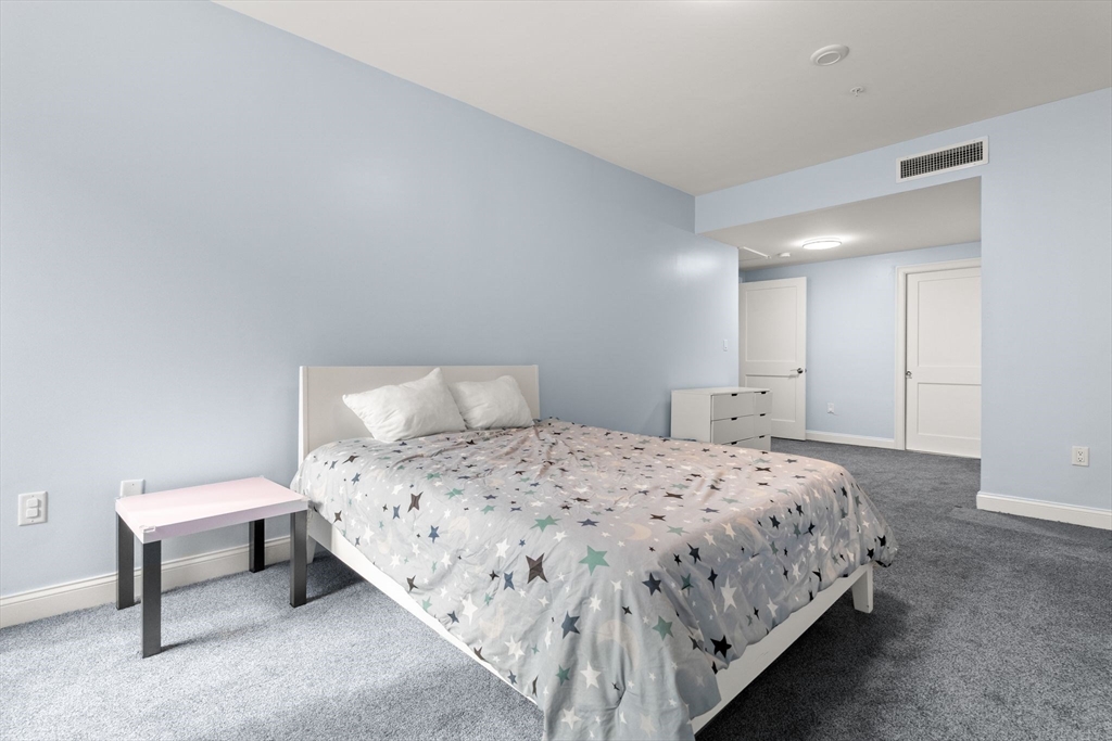 771 Harrison Avenue, Unit 206 Boston, MA 02118 - Photo 7 of 22 a bedroom with a bed and a lamp