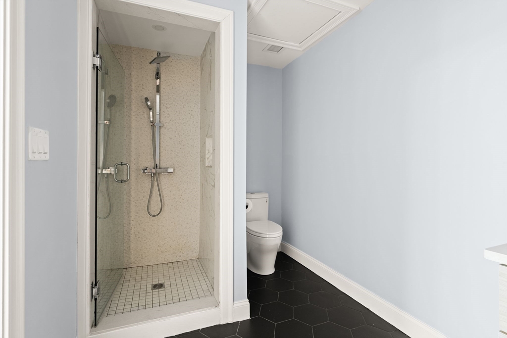 771 Harrison Avenue, Unit 206 Boston, MA 02118 - Photo 9 of 22 a bathroom with a granite countertop shower