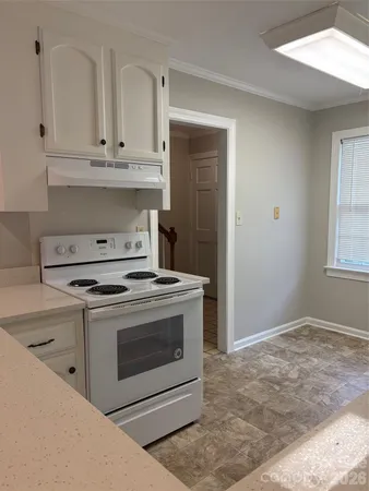 a stove top oven sitting inside of a kitchen