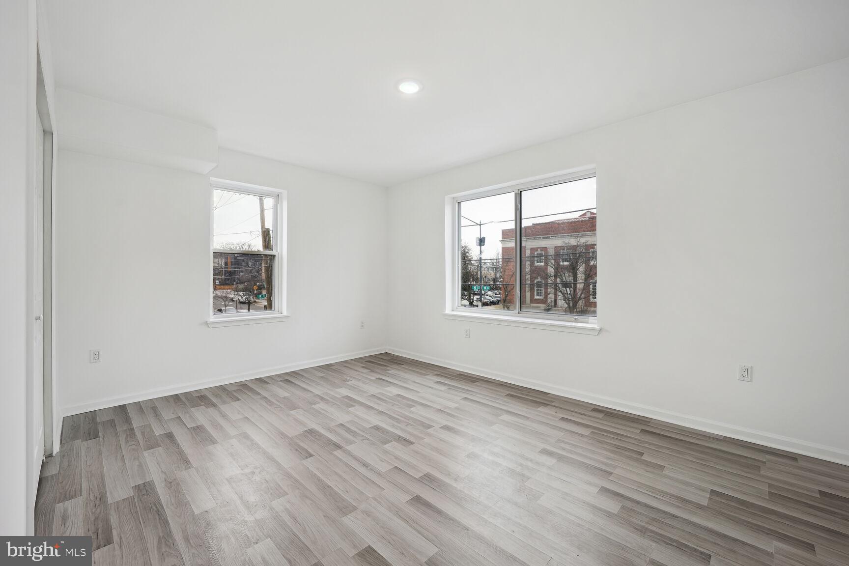 1642 16th Street Southeast, Unit 3 Washington, DC 20020 - Photo 12 of 22 an empty room with wooden floor and windows