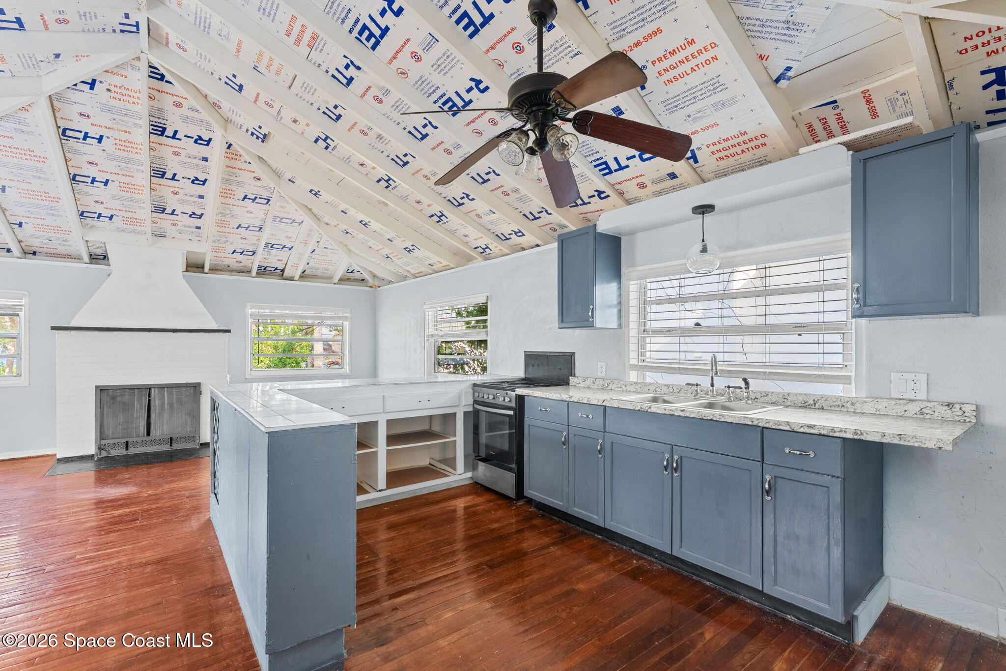 1101 Rockledge Drive Rockledge, FL 32955 - Photo 60 of 76 a kitchen with stainless steel appliances kitchen island granite countertop a sink cabinets and wooden floor