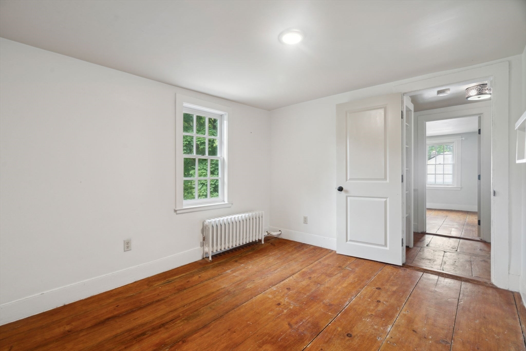 409 Main Street Townsend, MA 01474 - Photo 21 of 35 an empty room with wooden floor and windows