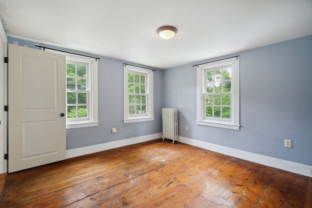 409 Main Street Townsend, MA 01474 - Photo 25 of 35 a view of empty room with wooden floor and fan