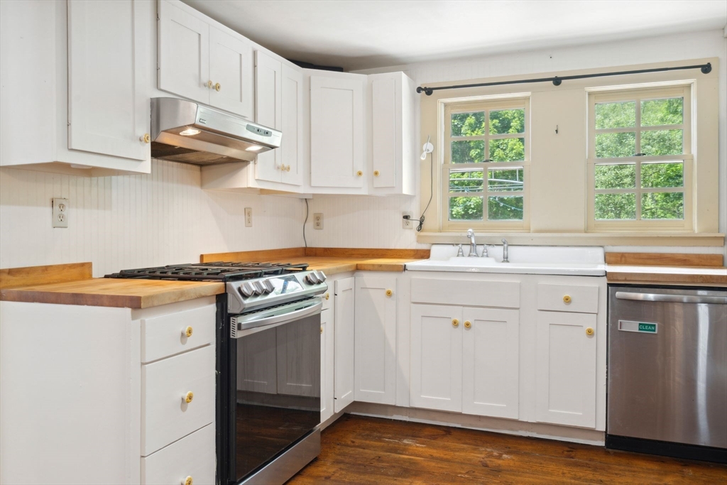 409 Main Street Townsend, MA 01474 - Photo 5 of 35 a kitchen with stainless steel appliances granite countertop a sink a stove and cabinets