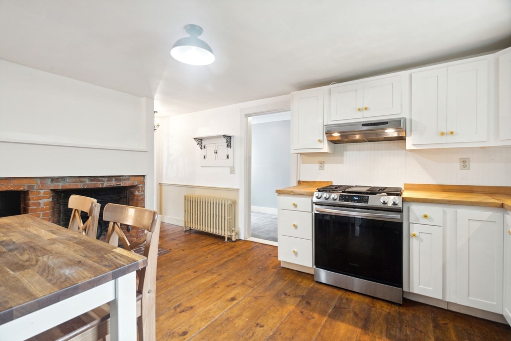 409 Main Street Townsend, MA 01474 - Photo 8 of 35 a kitchen with stainless steel appliances granite countertop a stove a sink and a refrigerator