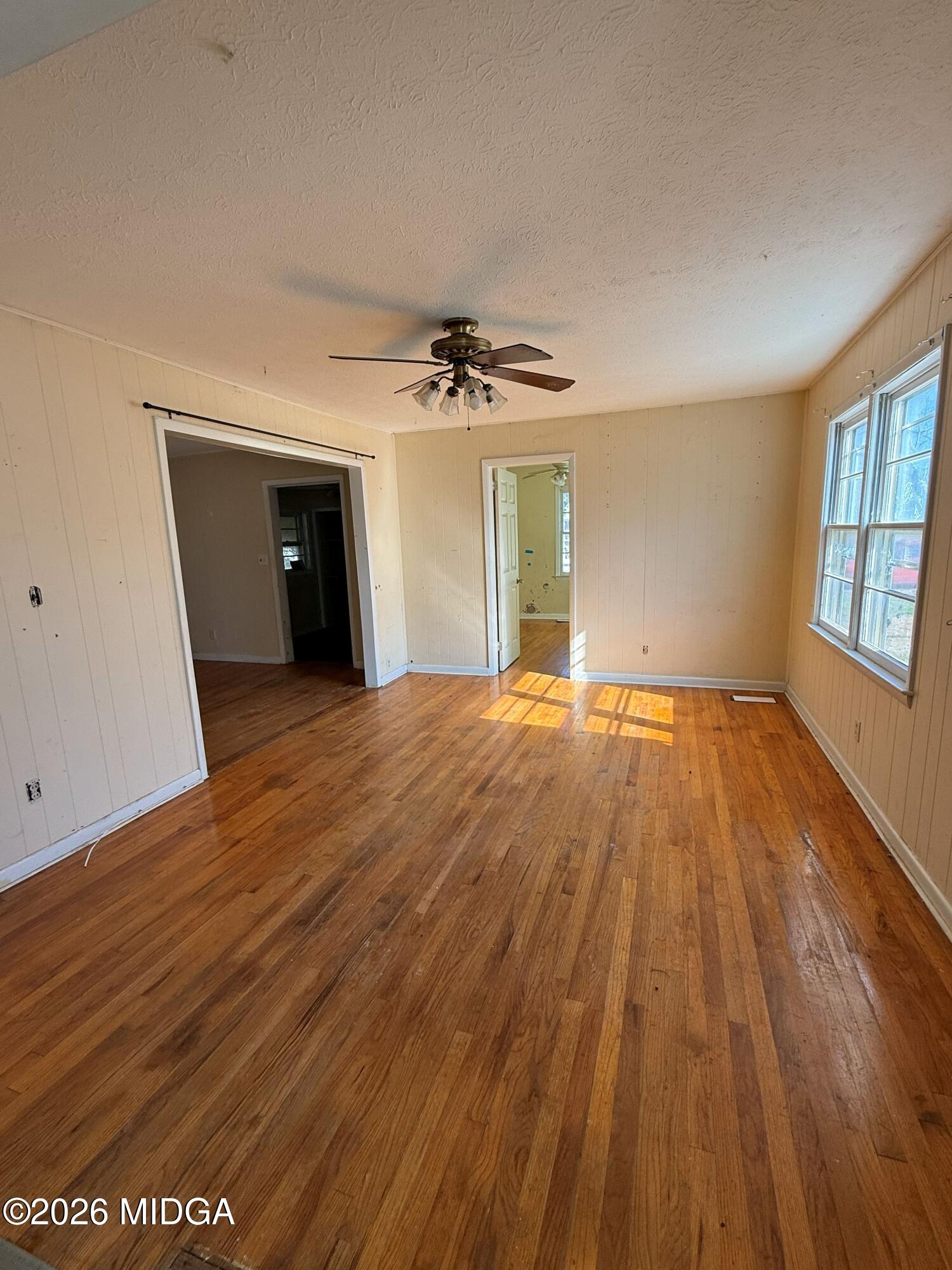 145 Edmondson Circle Cochran, GA 31014 - Photo 4 of 13 wooden floor in an empty room with a window