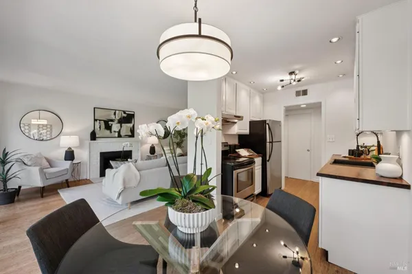 a living room with furniture potted plant and a mirror