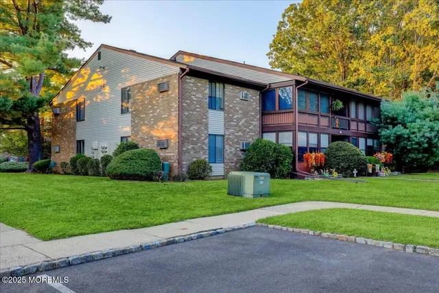 a view of a house with a yard and plants