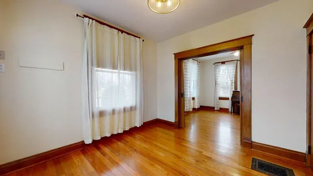 a view of a room with wooden floor and a balcony