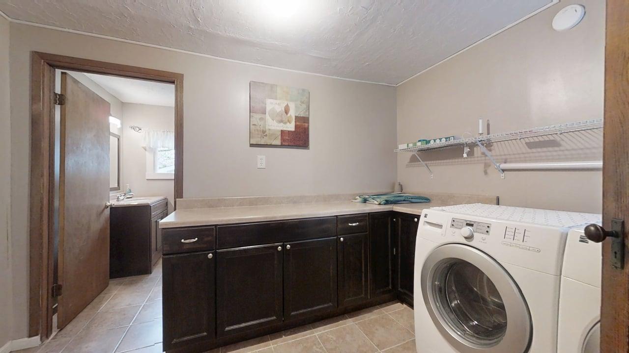 118 North Hartwell Street Gilman, IL 60938 - Photo 26 of 56 a utility room with cabinets dryer and washer