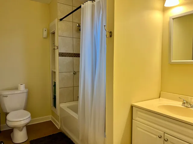a view of balcony with wooden floor and fence and trees