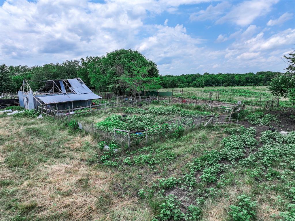 2190 County Road 2190 Commerce, TX 75428 - Photo 24 of 35 a backyard of a house with a yard and outdoor seating