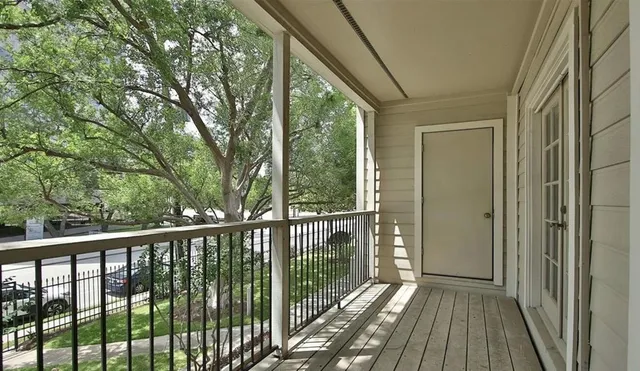 a view of a balcony with wooden floor
