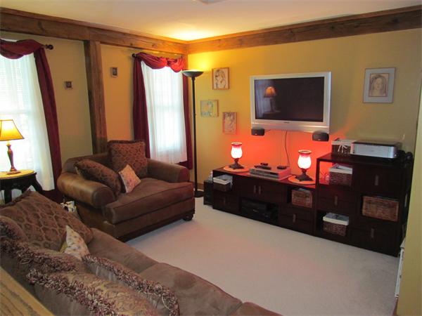 26 Nashaway Road Bolton, MA 01740 - Photo 8 of 15 a living room with furniture a flat screen tv and a couch