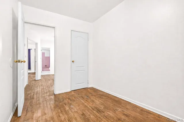 a view of hallway with wooden floor