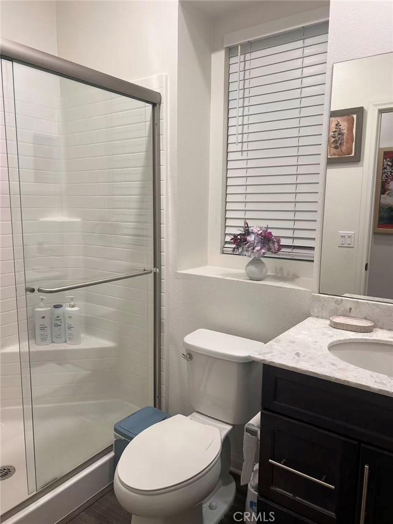 10664 Busch Street Spring Valley, CA 91978 - Photo 9 of 14 a bathroom with a sink a toilet a mirror and shower