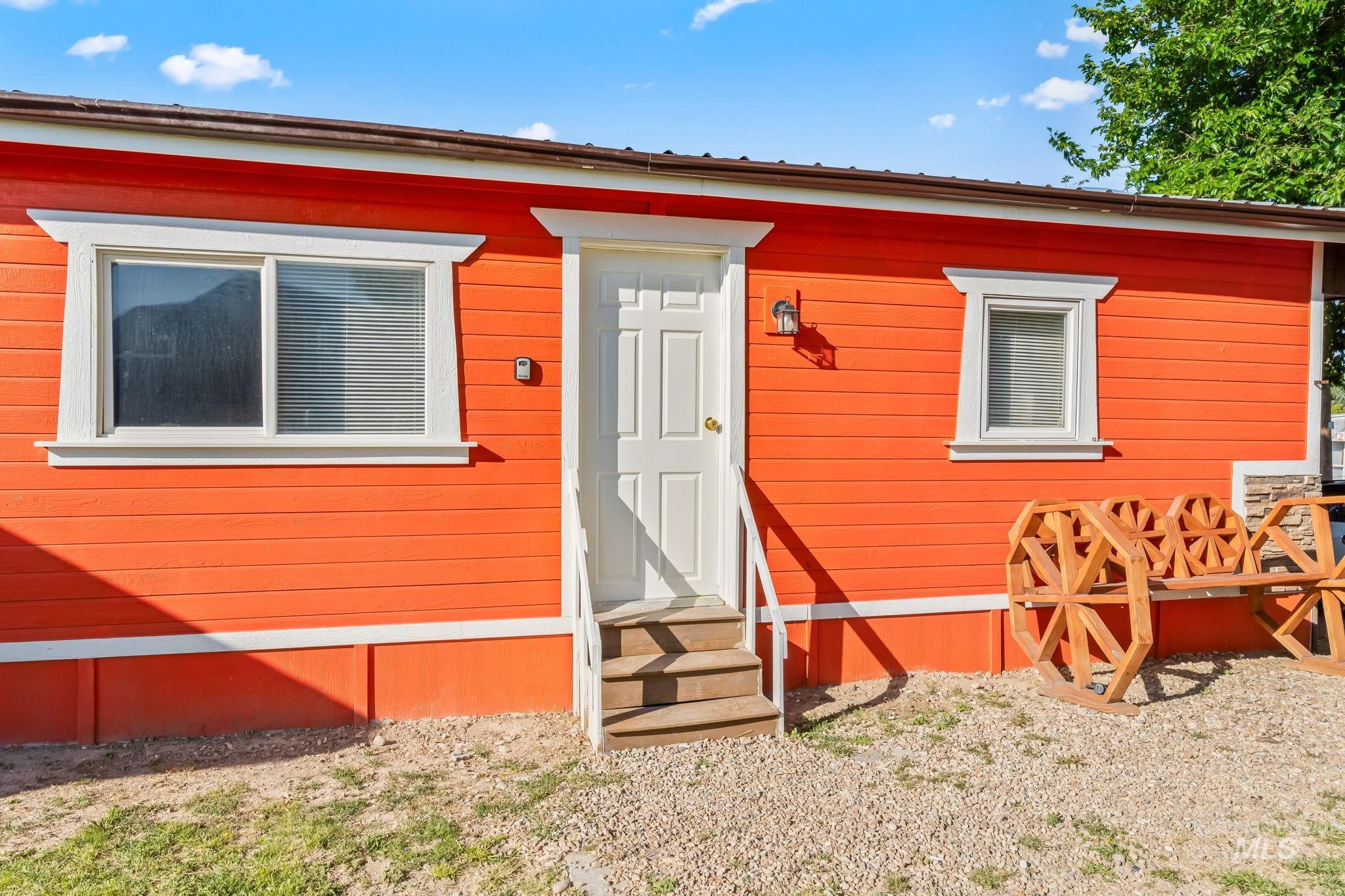 20106 Lower Pleasant Ridge Road, Unit 29 Caldwell, ID 83607 - Photo 2 of 19 Vibrant orange horizontal siding exterior with white trim