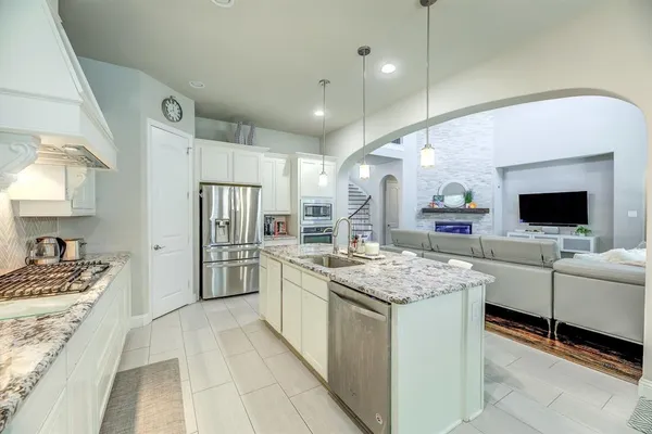 a kitchen with lot of counter top space and stainless steel appliances