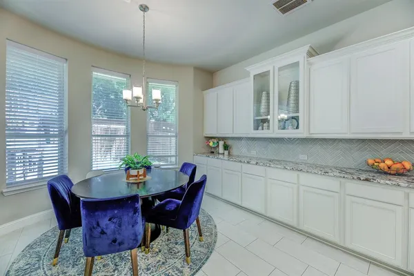 a view of a dining room with furniture and window