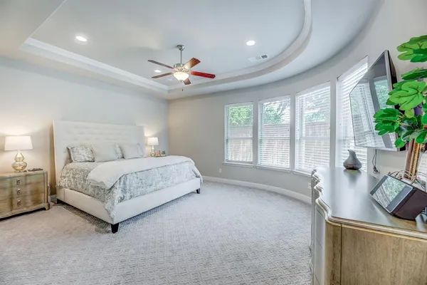 a bed room with a bed and a large window