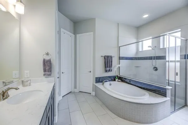 a bathroom with a bathtub and mirror