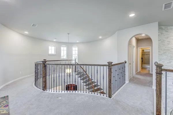 a view of a hallway with entryway and stairs