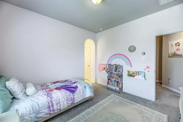 a bedroom with bed and a couch