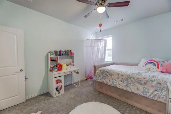 a bedroom with a bed and chandelier