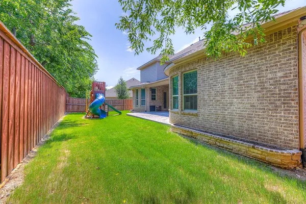 a view of a house with a backyard and a patio