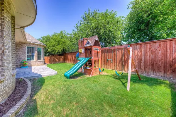 a view of an house with backyard and a slide