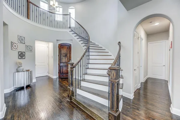 a view of entryway and hall with wooden floor