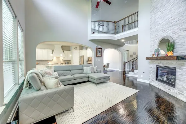a living room with furniture a fireplace and a large window