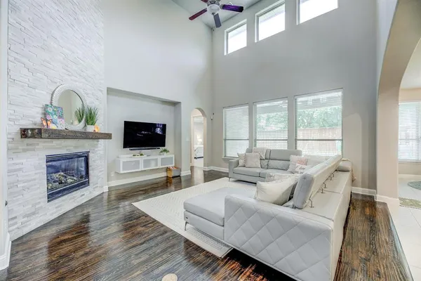 a living room with furniture fireplace and flat screen tv