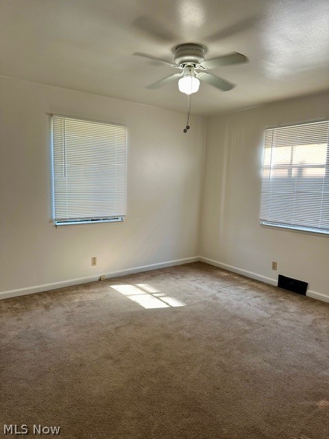 751 Thayer Street, Unit DOWN Akron, OH 44310 - Photo 10 of 25 Unfurnished room featuring ceiling fan and carpet flooring