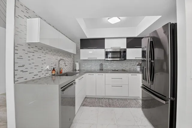 a kitchen with a sink microwave and refrigerator