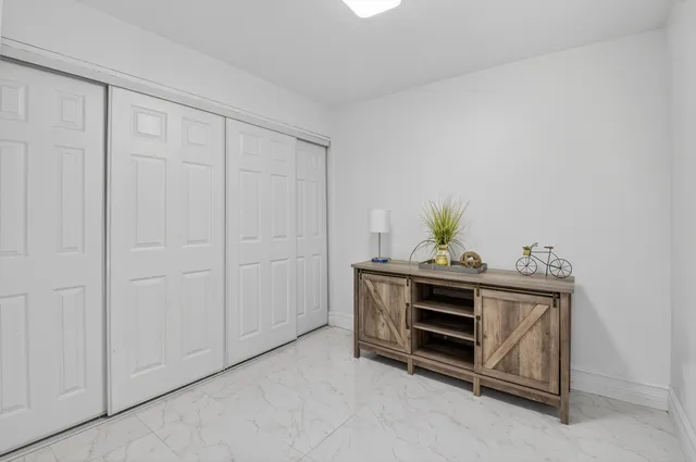 a view of bedroom with furniture and cabinet