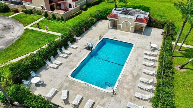 a view of swimming pool with outdoor seating and plants
