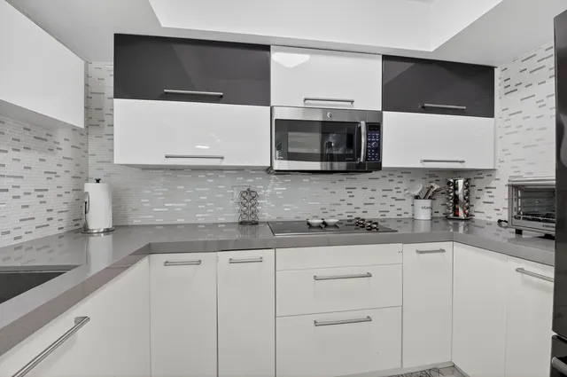 a kitchen with stainless steel appliances granite countertop a sink stove and microwave