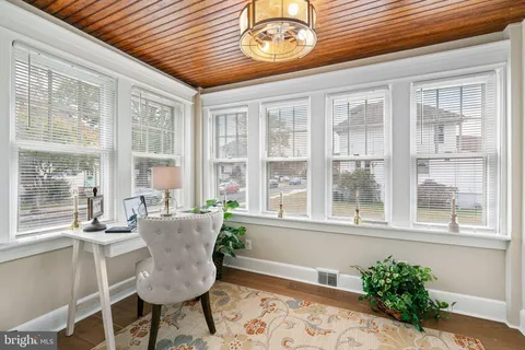a dining room with furniture a rug and a large window