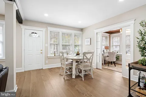 a dining room with furniture and wooden floor