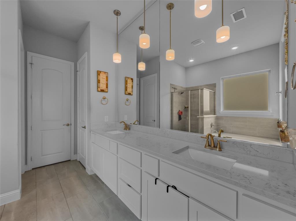 116 Chaco Drive Forney, TX 75126 - Photo 13 of 27 a bathroom with a double vanity sink and a mirror