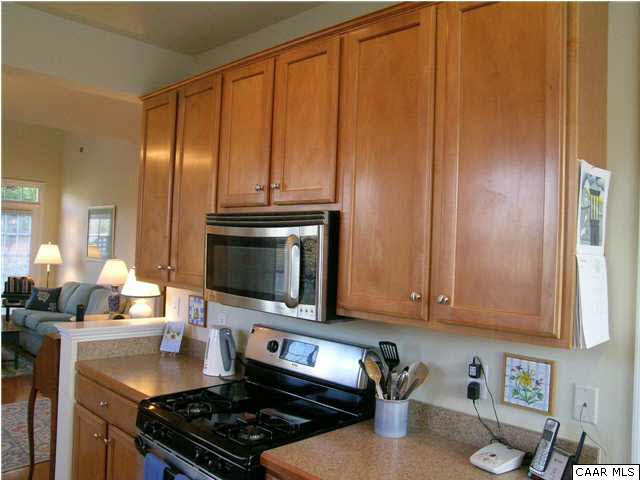 1310 Stoney Ridge Road Charlottesville, VA 22902 - Photo 11 of 22 a kitchen with granite countertop a stove top oven microwave and cabinets