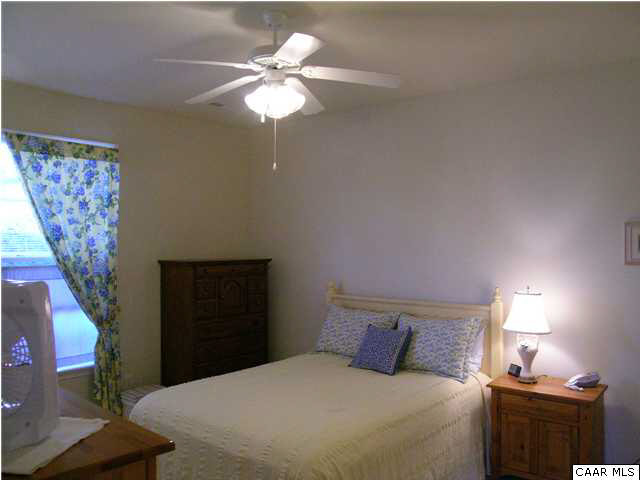 1310 Stoney Ridge Road Charlottesville, VA 22902 - Photo 13 of 22 a bedroom with a bed and a chandelier