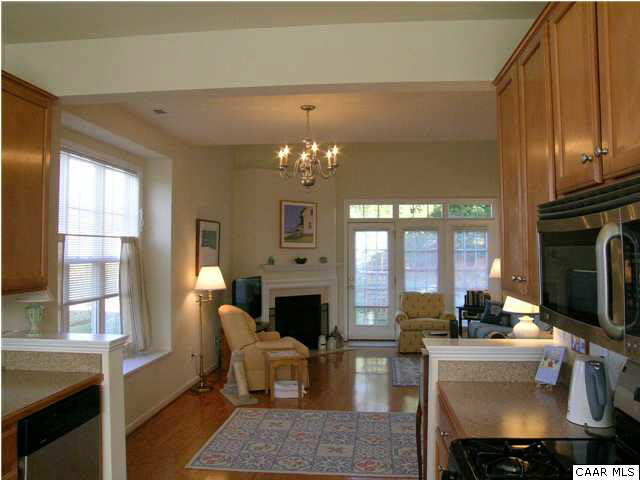 1310 Stoney Ridge Road Charlottesville, VA 22902 - Photo 2 of 22 a living room with furniture a fireplace and a chandelier