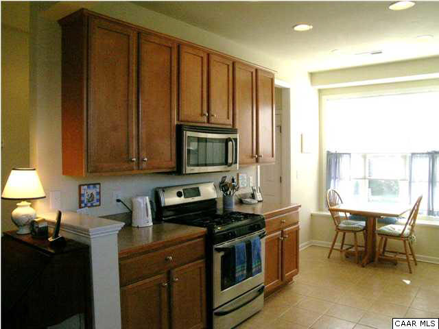 1310 Stoney Ridge Road Charlottesville, VA 22902 - Photo 3 of 22 a kitchen with stainless steel appliances granite countertop wooden cabinets a stove top oven a sink and dishwasher